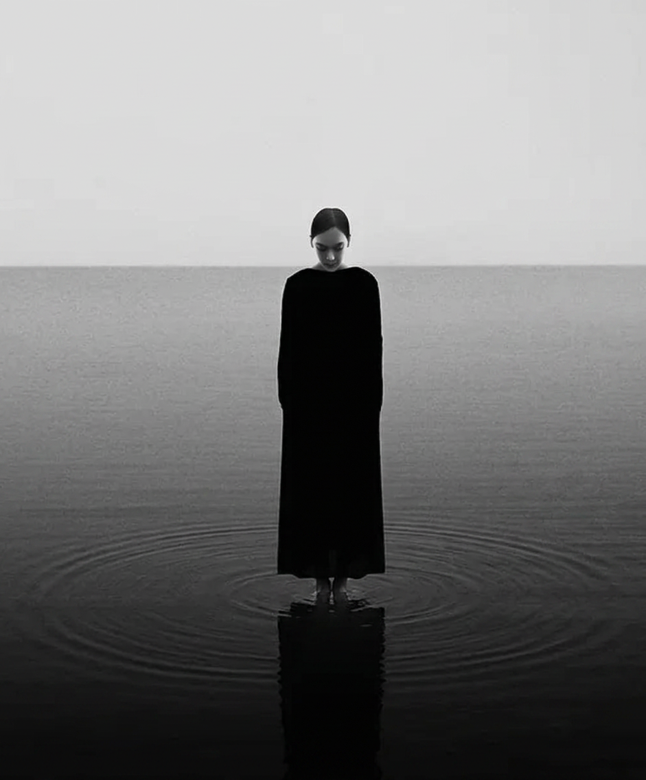 Woman standing still on open water